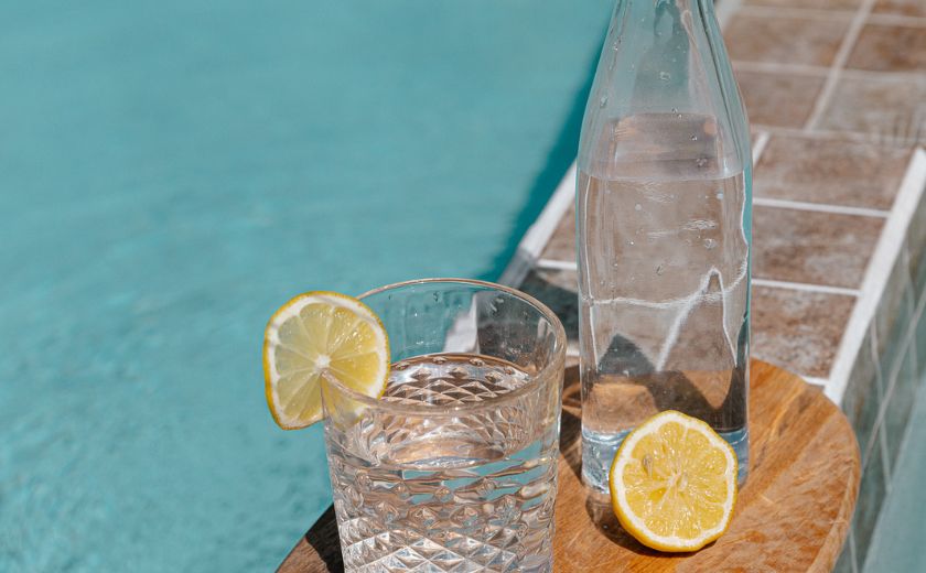 Drink tap water in Lefkada - glass with lemon by a pool