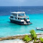 Tourist boat anchored near a turquoise beach in Lefkada, Greece