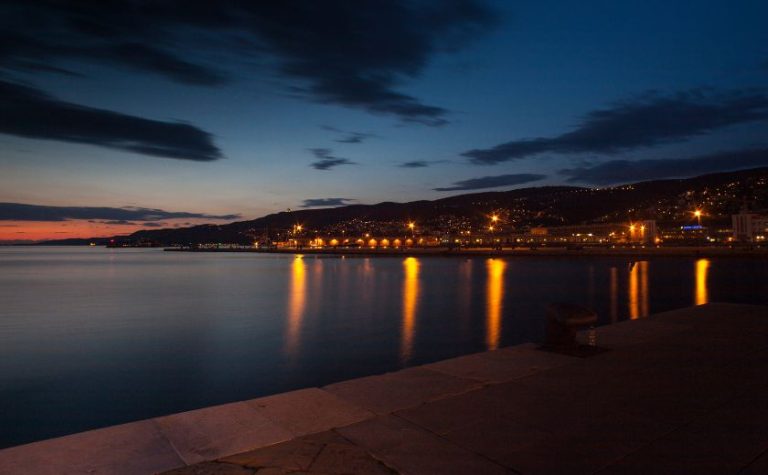 Night view of Lefkada Town promenade with lights reflecting on the sea