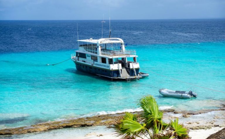 Tourist boat anchored near a turquoise beach in Lefkada, Greece