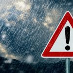 Warning sign during heavy rain—symbolizing unpredictable September weather in Lefkada.