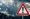 Warning sign during heavy rain—symbolizing unpredictable September weather in Lefkada.