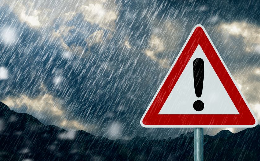 Warning sign during heavy rain—symbolizing unpredictable September weather in Lefkada.