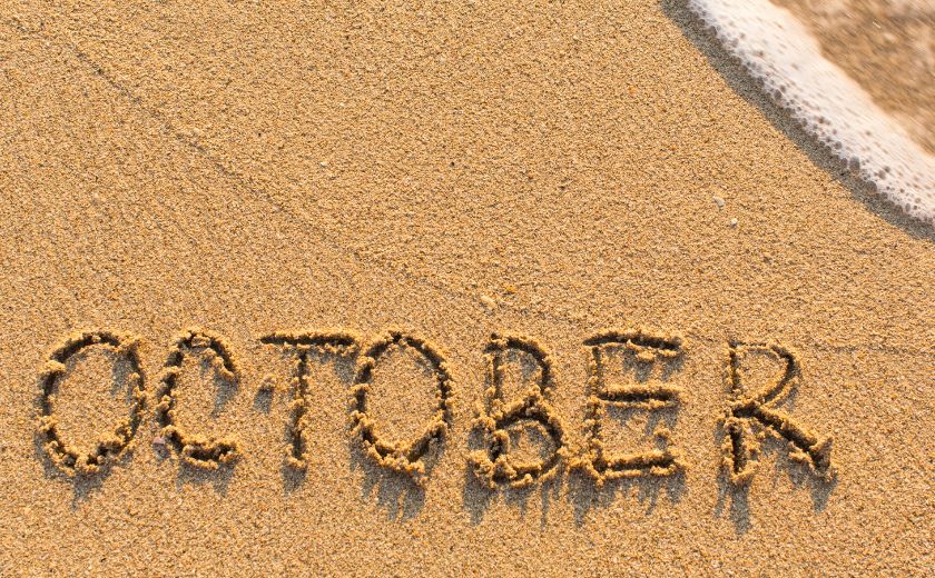 The word "October" written in the sand, representing peaceful autumn in Lefkada.
